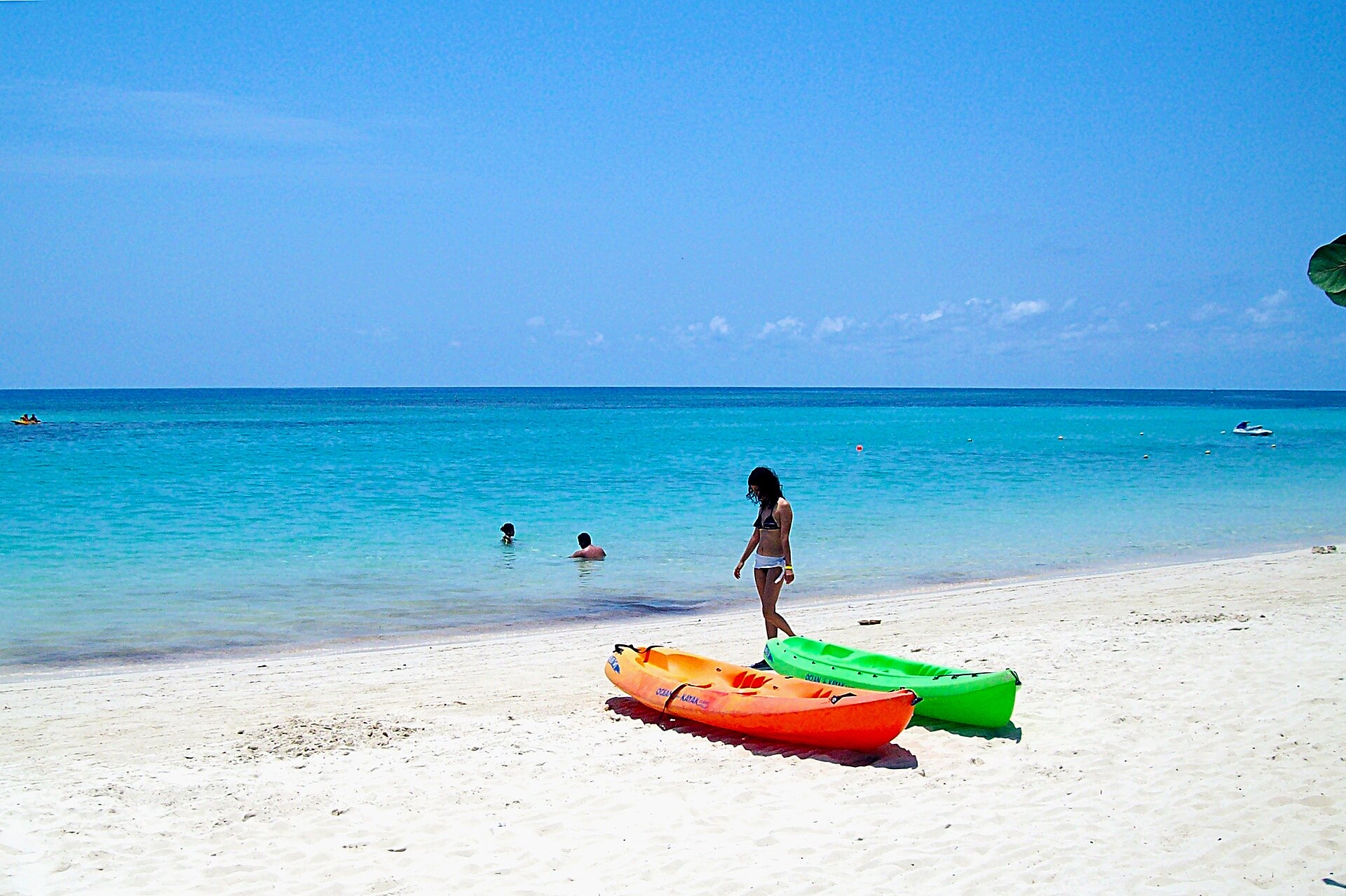 West Bay Beach on Roatan, Honduras, with kayaks on the sand and turquoise water